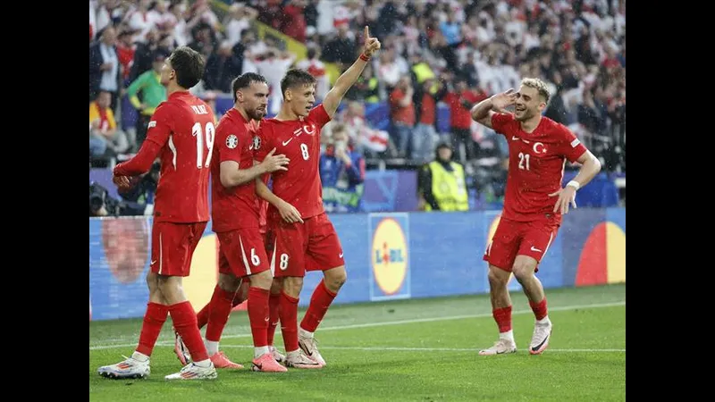 Cầu thủ Thổ Nhĩ Kỳ dũng mãnh vượt qua sự truy đuổi của cầu thủ Georgia trên sân cỏ Cầu thủ Thổ Nhĩ Kỳ dũng mãnh vượt qua sự truy đuổi của cầu thủ Georgia trên sân cỏ